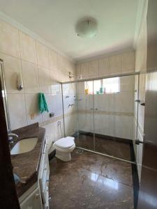 a bathroom with a toilet and a sink and a shower at República Os Bartira in Ouro Preto +27 photos