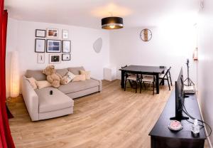 a living room with a couch and a table at L'Appart in Le Plessis-Robinson