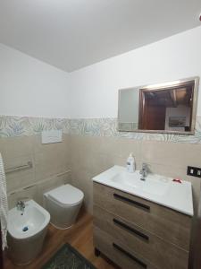 a bathroom with a sink and a toilet and a mirror at B&b da Ely in Ventimiglia di Sicilia +25 photos