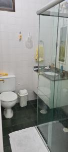 a bathroom with a toilet and a glass shower at Casa em Villagio na Riviera in Riviera de São Lourenço +6 photos