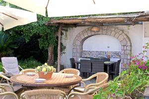a patio with a table and chairs and an archway at Casa il Terrazzino in Anacapri +33 photos