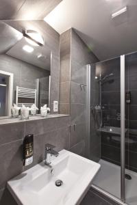 a bathroom with a sink and a shower at Café Pension Steffen in Sanitz