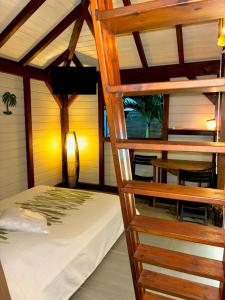 a bedroom with a bunk bed in a room at La Petite Créole - Bungalow de standing in Petit-Bourg