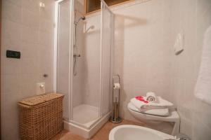 a bathroom with a shower and a toilet and a sink at Appartamento Centro Storico Riva - Happy Rentals in Riva del Garda