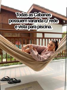 a girl laying in a hammock in a resort at Pousada Rosa Maria in Praia do Rosa