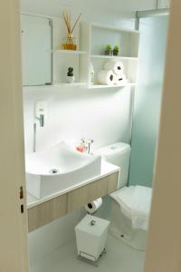 a white bathroom with a sink and a toilet at Pousada Bella Vista - no coração do Vale dos Vinhedos in Bento Gonçalves +101 photos