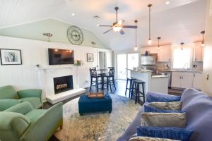 a living room with blue couches and a fireplace at Beautiful Home Walk to Water Dog Welcome in Yarmouth