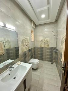 a bathroom with a sink and a toilet and a shower at Dream Inn Guest House Islamabad in Islamabad +37 photos