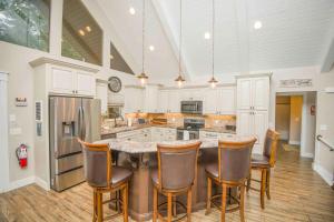 a kitchen with a large island with chairs around it at Nor Largo in Grantsboro +52 photos