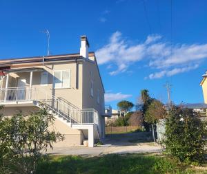 a building with a staircase on the side of it at Casa degli Ulivi - Apartment B in Porto San Giorgio