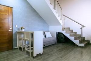 a living room with a couch and stairs at Estudio 1850 in La Paz