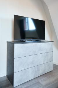 a tv sitting on top of a dresser at House Crocetta in Milan