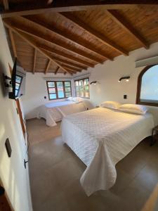a bedroom with two beds and a large window at Habitación con baño privado en casa de campo ubicada en Santa Elena in Santa Elena +37 photos