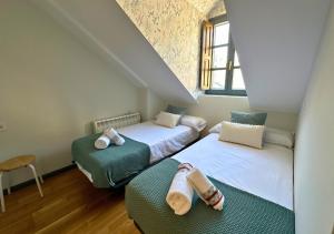 Postel nebo postele na pokoji v ubytování Caldares Exclusivo Ático en El Pueyo de Jaca