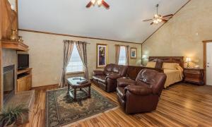 a living room with a couch and a bed at Appian Way Oliva Cottage in Fredericksburg +7 photos