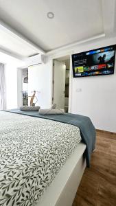a bedroom with a large bed with a tv on the wall at Ocean View Luxury Las Americas in Playa de las Americas +43 photos