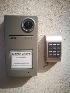 a mason zarishieper with a cell phone on a wall at Monolocale Maison Zanotti in Bologna