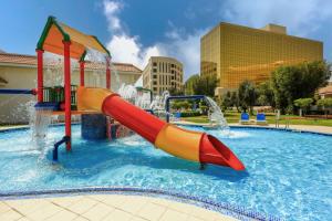 a water park with a slide in a pool at Radisson Blu Hotel, Doha in Doha