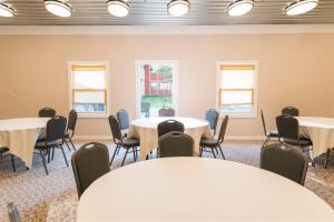 a room with tables and chairs and windows at Brown County Inn in Nashville +47 photos