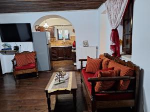 a living room with a couch and a table at Gold King Apartment in Áyios Vasílios