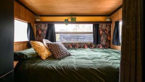 a bed in the back of a tiny house at Piccolo Lane Daylesford in Daylesford