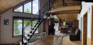 a spiral staircase in a house with a living room at Chalet spa rivière saint Maurice in Grandes-Piles