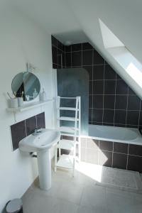 a bathroom with a sink and a toilet and a ladder at Jolie maison de vacances in Concarneau