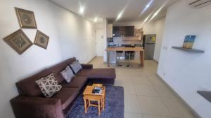 a living room with a couch and a table at Riviera Residence Luxury by Cozy in Accra