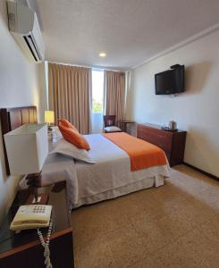 Postel nebo postele na pokoji v ubytování Hotel Anaconda