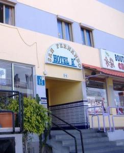 a hotel building with a sign on the front of it at Hostal Casa de Huéspedes San Fernando in Playa del Ingles