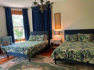 a bedroom with two beds and a window at Large Historical Home for Groups Walk to Downtown! in Baptist Hospital Heliport +57 photos