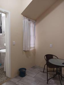 a room with a table and a sink and a window at POSADA del MAR in Puerto Escondido