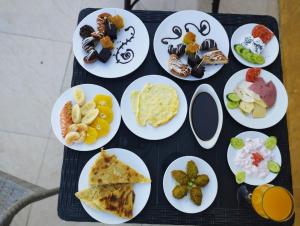 a bunch of plates of food on a table at golden mask pyramids view in Cairo
