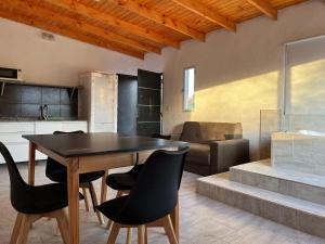 a kitchen and dining room with a table and chairs at Posada La Candelaria in Cosquín