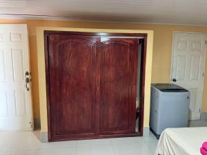 a wooden door in the corner of a room at Havana in Rivas