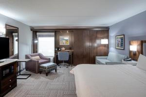a hotel room with a bed and a desk at Hampton Inn Janesville in Janesville +38 photos
