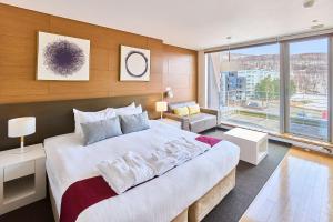a bedroom with a large bed and a large window at Niseko Central Condominiums in Kutchan