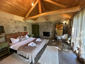 a bedroom with a large bed in a room with wooden ceilings at Подковите in Karlovo