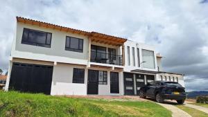 a car parked in front of a house at Apartamento Entero 201 NUEVO in Guatavita
