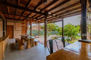 an open patio with a wooden table and chairs at Casa do Lago em Alter do Chão in Alter do Chao