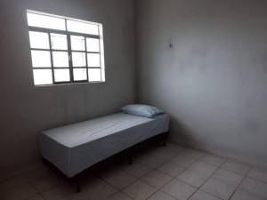 a small bedroom with a bed and a window at 18 - Apto com Estac Gratis e Conforto in Paragominas