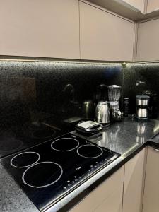 a kitchen counter with a stove top in a kitchen at Loft, Próximo ao Consulado EUA in Porto Alegre +37 photos