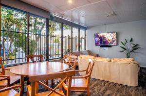 a living room with a table and a couch at BeHome in Gold Coast