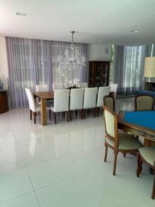 a dining room with a dining table and chairs at Casa de Luxo no Condomínio Enseada in Xangri-lá