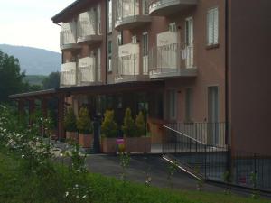 a large building with balconies on the side of it at Residence Hotel Matilde in Carpineti