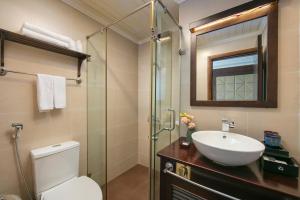 a bathroom with a toilet and a sink and a shower at Mila Cruises in Ha Long +76 photos