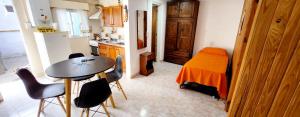 a kitchen with a table and chairs in a room at Lo de Liliana in Tanti