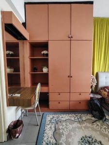 a dining room with a table and a cabinet at Anitas place in Port Dickson