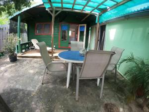 a patio with a table and chairs and a house at Island Relax Retreat in Willemstad