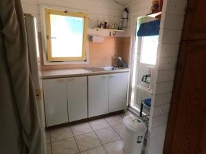 a small kitchen with a sink and a window at Island Relax Retreat in Willemstad